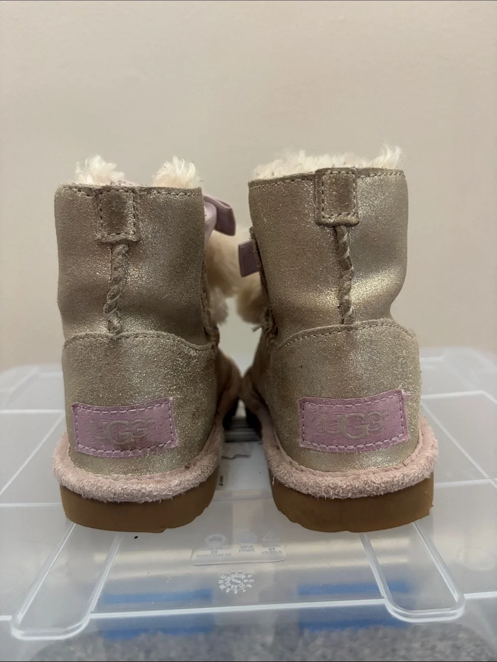 UGG Kids Metallic Gold Pom-Pom Boots with Pink Ribbon